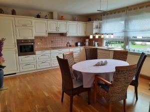 a kitchen with a table and chairs in it at Ferienhaus Karla in Schmidtheim