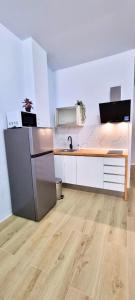 Vacansis Apartamentos Bulevar في فالنسيا: مطبخ فارغ مع مغسلة وثلاجة