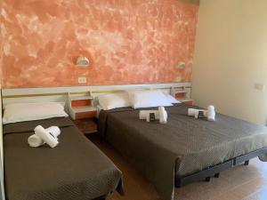 Postel nebo postele na pokoji v ubytování Hotel Majestic