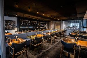 a row of tables and chairs in a restaurant at Scandic Opus Horsens in Horsens