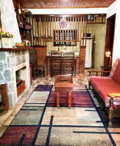 Casa do Passarinho في كامبوس دو جورداو: غرفة معيشة مع أريكة ومدفأة