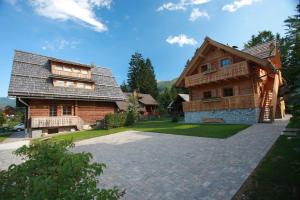 a house with a stone driveway in front of it at Apartments Brina in Bohinj