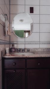 a bathroom with a sink and a mirror at CURTA! | Casa dos Pássaros - Campo Alegre in Campo Alegre