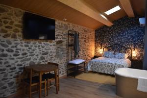 a bedroom with a bed and a tv and a table at Cabana de Pili in A Estrada +25 photos