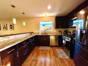 a kitchen with black cabinets and a sink and a window at Sunrise View in Rocklin