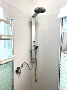 a shower with a shower head in a bathroom at Apartments4you Maria in Bat Yam