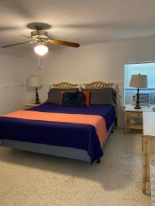 a bedroom with a bed and a ceiling fan at Funky Downtown Pad Pets OK Near Intercoastal in St. Augustine