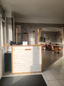 a counter in a room with a table and chairs at Hotel Le Beauregard in Divonne-les-Bains