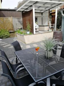 a black table and chairs on a patio at Ferienhaus Rosaly in Stolberg