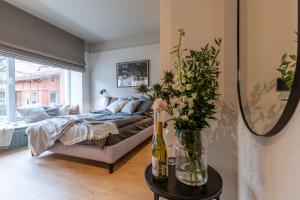a bedroom with a bed and a vase of flowers on a table at Monciak Elegance - Plaża in Sopot