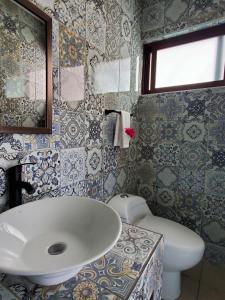 a bathroom with a sink and a toilet at Hotel Posada Camelinas in P&aacute;tzcuaro