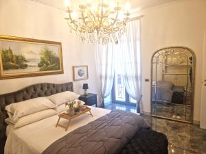 a bedroom with a large bed and a chandelier at la corte dei filangieri rooms in Candida