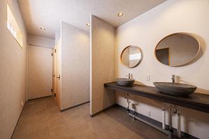 a bathroom with two sinks and two mirrors at NAGOMI CAMP - Vacation STAY 48650v in Nasushiobara