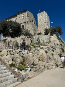 a person standing in front of a castle at Studio central place malespine proche port Vauban in Antibes
