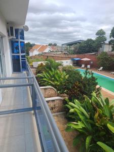 a balcony with a view of a swimming pool at Hotel Les Cygnes in Antananarivo
