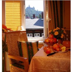 a table with a plate of fruit on it with a window at Altstadt-Refugium - Schlossblick, Sauna, Parkplatz, Innenstadt, Wow Sky Sport BL in Wernigerode