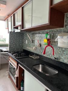 a kitchen with a sink and a counter top at Apto e escritório no Renascença in São Luís