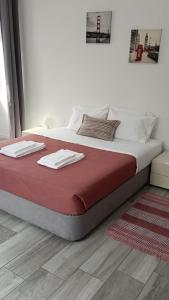 a large bed with two towels on top of it at Seaside House in Ponta Delgada
