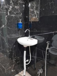 a bathroom with a sink and a toilet at M k home stay in Ujjain
