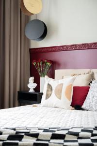 a bedroom with a white bed with a red wall at Apartament Bajka in Grudziądz +5 photos