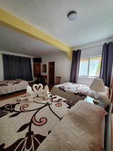 a bedroom with two beds and a large rug at Hotel Posada Camelinas in P&aacute;tzcuaro