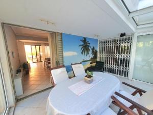 a dining room with a table and a balcony at Kavouri Seaside 85sqm Apartment 5' from the beach in Athens