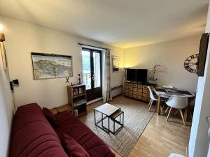 ein Wohnzimmer mit einem Sofa und einem Tisch in der Unterkunft Résidence Le Grand Adret - 2 Pièces pour 4 Personnes 024 in Villard-de-Lans