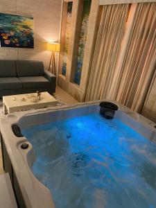 a large bath tub in a living room at Hotel Valz in Velipojë
