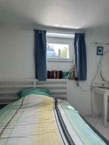 a bedroom with a bed with a window and a mirror at Simple room in Luxembourg city in Luxembourg