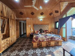 a bedroom with a large bed and wooden walls at Srinagar Group Of Hotels in Srinagar