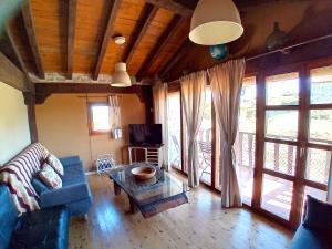 a living room with a couch and a table at Casasdetrevijano Mirador de Mateo in Soto en Cameros