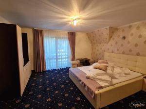 Sapphire Chalet-un cadru elegant في موياشيو دي سوس: غرفه فندقيه بسرير ونافذه