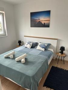 a bedroom with a bed with two pillows on it at Apartment Mila in Ugljan