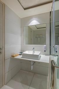 a bathroom with a sink and a mirror at Sandoz Amritsar - Lawrence Road in Amritsar