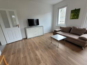a living room with a couch and a flat screen tv at Ferienwohnung und Monteurzimmer in Albstadt