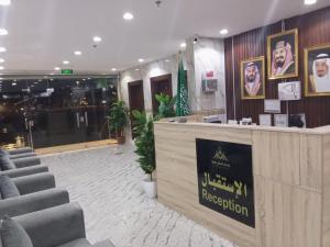 a hotel lobby with a reception desk and chairs at فندق انسام طيبة للضيافة in Medina