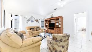 a living room with two couches and a tv at New house 3-room pool lake view in Port Charlotte