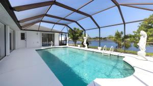 a swimming pool in a house with a view of the water at New house 3-room pool lake view in Port Charlotte