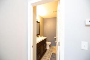 a bathroom with a sink and a toilet and a mirror at 3 Bedroom Family Friendly Home in Anchorage