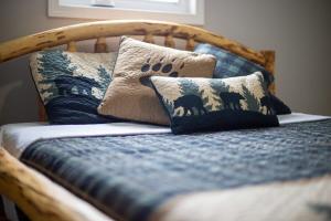 a bed with a wooden headboard with pillows on it at 3 Bedroom Family Friendly Home in Anchorage