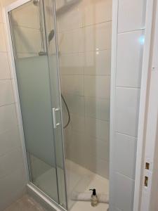 a shower with a glass door in a bathroom at T2 Colombes proche toutes commodités in Colombes