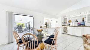 a kitchen and dining room with a glass table and chairs at New house 3-room pool lake view in Port Charlotte