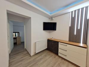 Zimmer mit einem Flachbild-TV an der Wand in der Unterkunft Romanescu One Apartament in Craiova