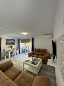 a living room with a couch and a table at Brisa del mar in Tarajalejo