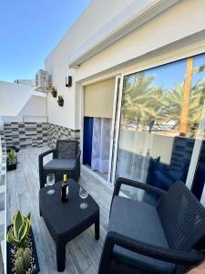 a patio with two chairs and a table at Brisa del mar in Tarajalejo
