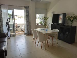 - un salon avec une table, des chaises et une télévision dans l'établissement Apartamento Bajamar Tenerife, à Bajamar