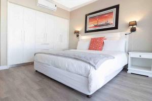 a bedroom with a large white bed in a room at 522 The Granger in Cape Town