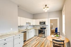 a kitchen with white cabinets and a wooden table at Modern Augusta Vacation Rental about 1 Mi to Colleges! in Augusta