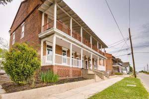 a brick building with a balcony on a street at Renovated Augusta Apartment about 1 Mi to Downtown! in Augusta