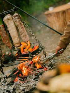 a person is cooking food over a campfire at PUQIO in Yanque